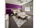 Bedroom with purple accent wall, vaulted ceiling, and gray carpet at 4900 Quinlan Ave, Las Vegas, NV 89130