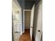 Hallway view showing a bathroom and open shelving in a closet at 4900 Quinlan Ave, Las Vegas, NV 89130