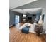 Open concept living room with hardwood flooring, a fireplace, and a ceiling fan at 4900 Quinlan Ave, Las Vegas, NV 89130