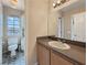 Bathroom featuring a single sink vanity and a mirror with accent lighting at 504 Landra Ln, Henderson, NV 89015