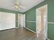 Bedroom with green walls, wood flooring and ceiling fan at 504 Landra Ln, Henderson, NV 89015