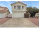 Two-story home featuring a two-car garage, stucco exterior, concrete driveway, and minimal landscaping at 504 Landra Ln, Henderson, NV 89015