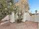 Charming single-story home with stucco pillars, desert landscaping, and mature trees at 504 Landra Ln, Henderson, NV 89015