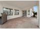 Patio with brick pavers, outdoor kitchen, desert landscaping, and views into kitchen at 504 Landra Ln, Henderson, NV 89015