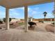 Covered patio with brick floor overlooks landscaped backyard, pool, and cabana at 504 Landra Ln, Henderson, NV 89015