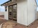 White storage shed with dark brown double doors and window at 504 Landra Ln, Henderson, NV 89015