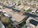 Aerial shot captures a community with mature trees, manicured lawns, and a private backyard with a pool at 1053 Plentywood Pl, Henderson, NV 89002