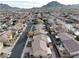 An elevated view of a neighborhood with a mountain backdrop highlights the close proximity to local amenities at 1053 Plentywood Pl, Henderson, NV 89002