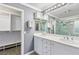 This bathroom features a double vanity, an open closet, and neutral paint at 1053 Plentywood Pl, Henderson, NV 89002