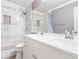 This primary bathroom features a double vanity, a decorative tile shower, and neutral paint at 1053 Plentywood Pl, Henderson, NV 89002