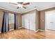 Large bedroom featuring wood floors, a ceiling fan, natural light, and a closet at 1053 Plentywood Pl, Henderson, NV 89002