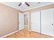 Bedroom with wood floors, closet, ceiling fan, and open doorway to another room at 1053 Plentywood Pl, Henderson, NV 89002