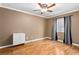 Empty bedroom featuring wood floors, a ceiling fan, natural light and a dresser at 1053 Plentywood Pl, Henderson, NV 89002