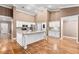 Kitchen featuring a center island with granite countertop and white cabinetry at 1053 Plentywood Pl, Henderson, NV 89002