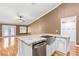 Kitchen island with stainless steel sink, dishwasher, and granite countertop at 1053 Plentywood Pl, Henderson, NV 89002