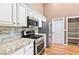 Kitchen area featuring stainless steel appliances and granite countertops at 1053 Plentywood Pl, Henderson, NV 89002