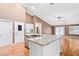 Kitchen featuring a center island with granite countertop and white cabinetry at 1053 Plentywood Pl, Henderson, NV 89002