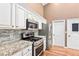 Kitchen area featuring stainless steel appliances and granite countertops at 1053 Plentywood Pl, Henderson, NV 89002