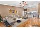 Staged living room with comfortable seating and an open view of the kitchen at 1053 Plentywood Pl, Henderson, NV 89002