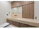 Modern bathroom with floating sink and wood cabinets at 21 Rockstream Dr, Henderson, NV 89012