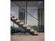 Modern floating staircase with glass and metal accents at 21 Rockstream Dr, Henderson, NV 89012