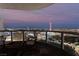Enjoy this balcony view with comfortable seating overlooking the illuminated Las Vegas cityscape at twilight at 322 Karen Ave # 3707, Las Vegas, NV 89109