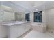 Modern bathroom featuring double sinks, soaking tub, and a separate glass-enclosed shower at 322 Karen Ave # 3707, Las Vegas, NV 89109