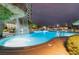 Relaxing swimming pool area featuring a waterfall and lush landscaping, ideal for evening relaxation at 322 Karen Ave # 3707, Las Vegas, NV 89109