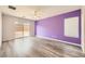 Spacious bedroom with wood-look floors, and a purple accent wall at 7745 Tyrell Peaks St, Las Vegas, NV 89139