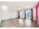 Spacious bedroom with wood-look floors and sliding glass door to patio at 7745 Tyrell Peaks St, Las Vegas, NV 89139
