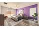 Main bedroom with plush bed, wood floors and access to backyard at 7745 Tyrell Peaks St, Las Vegas, NV 89139
