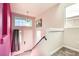 Bright entryway with pink walls, white door and staircase at 7745 Tyrell Peaks St, Las Vegas, NV 89139