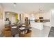 Modern kitchen with white cabinets, granite island and hardwood floors at 7745 Tyrell Peaks St, Las Vegas, NV 89139