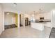 Modern kitchen with white cabinets, granite island and hardwood floors at 7745 Tyrell Peaks St, Las Vegas, NV 89139