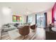 Spacious living room with hardwood floors, sectional sofa, and sliding glass doors at 7745 Tyrell Peaks St, Las Vegas, NV 89139