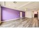 Open living room with hardwood floors and purple accent wall at 7745 Tyrell Peaks St, Las Vegas, NV 89139