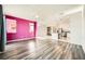 Open living room with wood-look floors and a view into the kitchen at 7745 Tyrell Peaks St, Las Vegas, NV 89139