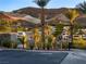 Aerial view of Lago Vista community with lake, palm trees, and mountain backdrop at 102 Appia Pl, Henderson, NV 89011