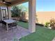 Covered patio with artificial turf and dining area at 114 Antler Square Ln, Henderson, NV 89011