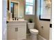 Powder room with white vanity, black fixtures, and neutral color palette at 114 Antler Square Ln, Henderson, NV 89011