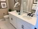 Elegant bathroom with double vanity, white cabinets, and black matte fixtures at 114 Antler Square Ln, Henderson, NV 89011