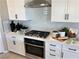 Kitchen features white cabinets, stainless steel appliances, and subway tile backsplash at 114 Antler Square Ln, Henderson, NV 89011