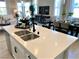 Island kitchen with double sink, white cabinets and modern fixtures at 114 Antler Square Ln, Henderson, NV 89011