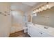 Bathroom with a bathtub, double vanity, and updated flooring at 1565 Pasture Ln, Las Vegas, NV 89110