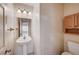 Small bathroom with pedestal sink and toilet at 1565 Pasture Ln, Las Vegas, NV 89110