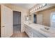 Bathroom with double vanity, light wood cabinets, and tile flooring at 1565 Pasture Ln, Las Vegas, NV 89110