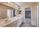 Double vanity bathroom with tile flooring and mirrored medicine cabinets at 1565 Pasture Ln, Las Vegas, NV 89110