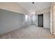 Bright bedroom with grey walls, carpet, and a double-door closet at 1565 Pasture Ln, Las Vegas, NV 89110