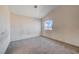 Upstairs bedroom with a large window and wall-to-wall carpet at 1565 Pasture Ln, Las Vegas, NV 89110