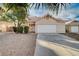 House with a white garage door and palm trees in the front at 1565 Pasture Ln, Las Vegas, NV 89110